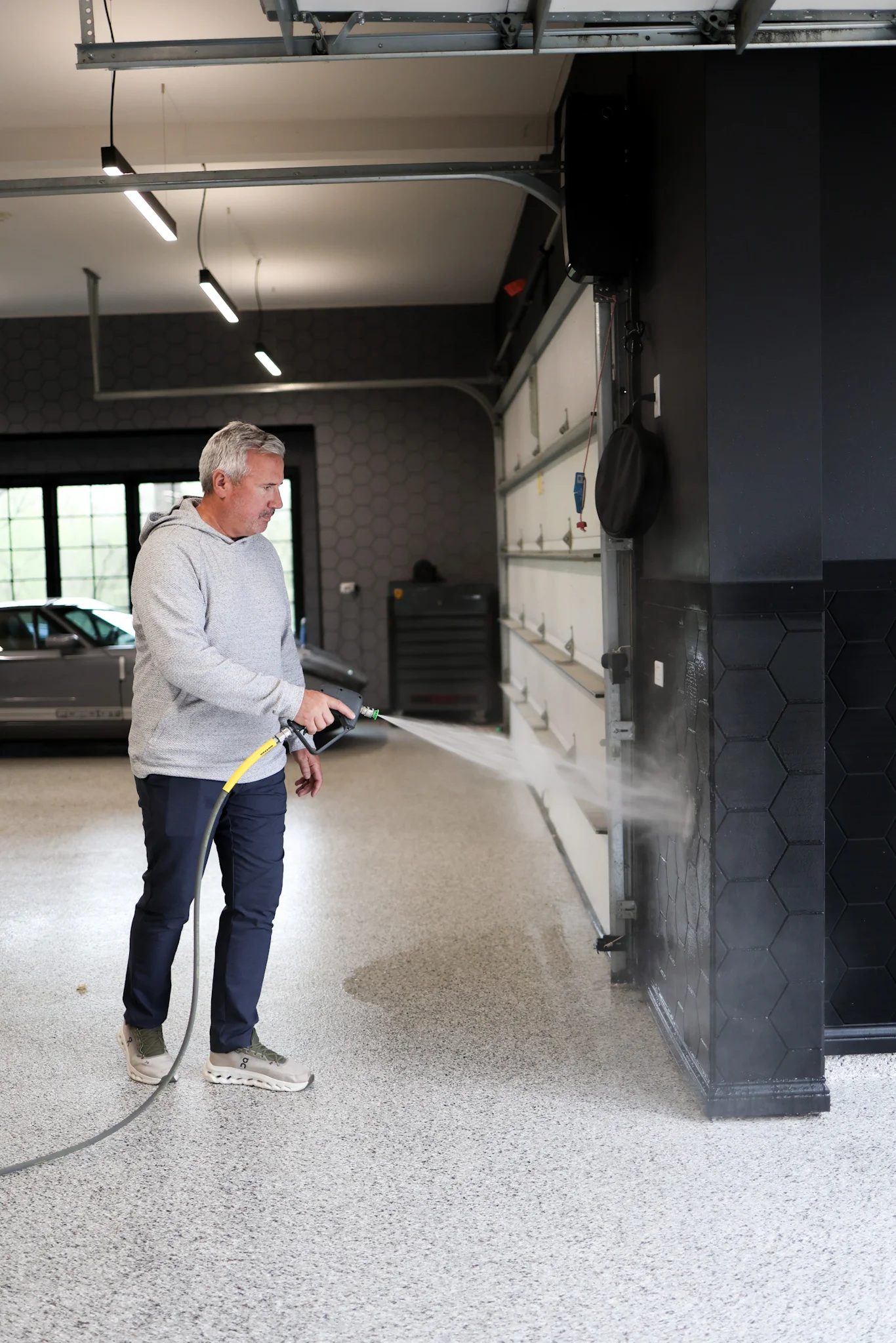 Person spray cleaning surface to apply ferreon tile